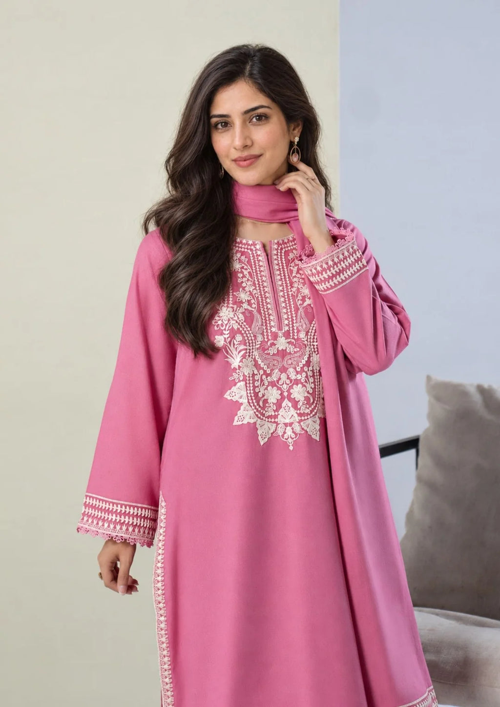 Close-up of ivory embroidery on pink shirt neckline and cuffs