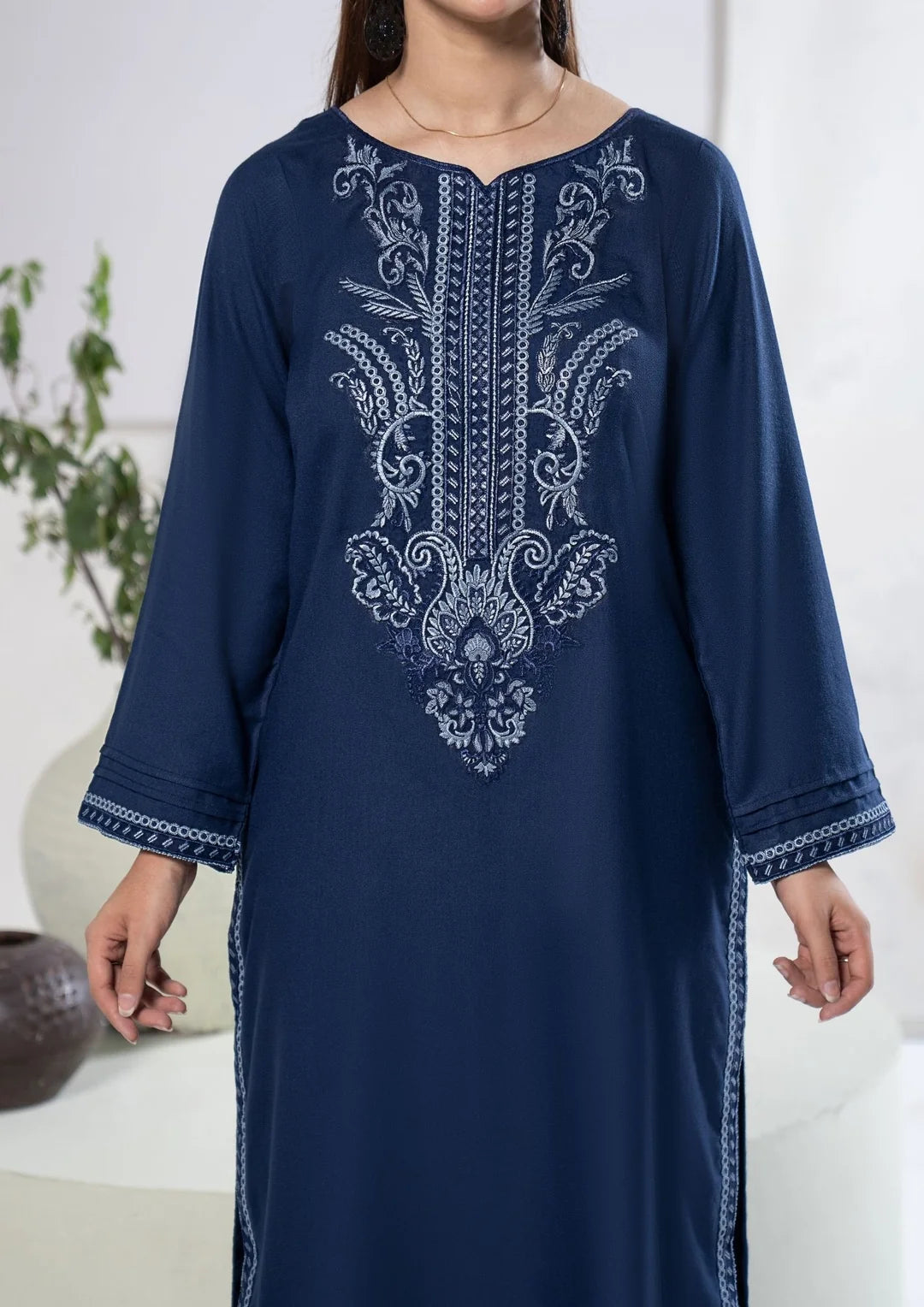 Contrasting neckline and bodice embroidery on navy blue shirt