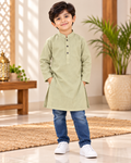 Boy wearing a light green kurta with dark buttons, styled with blue jeans