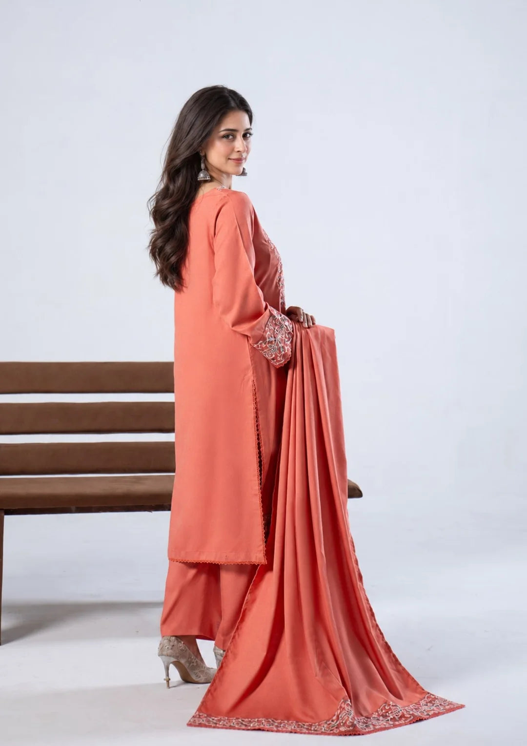 Back view of coral three-piece outfit and embroidered shawl border