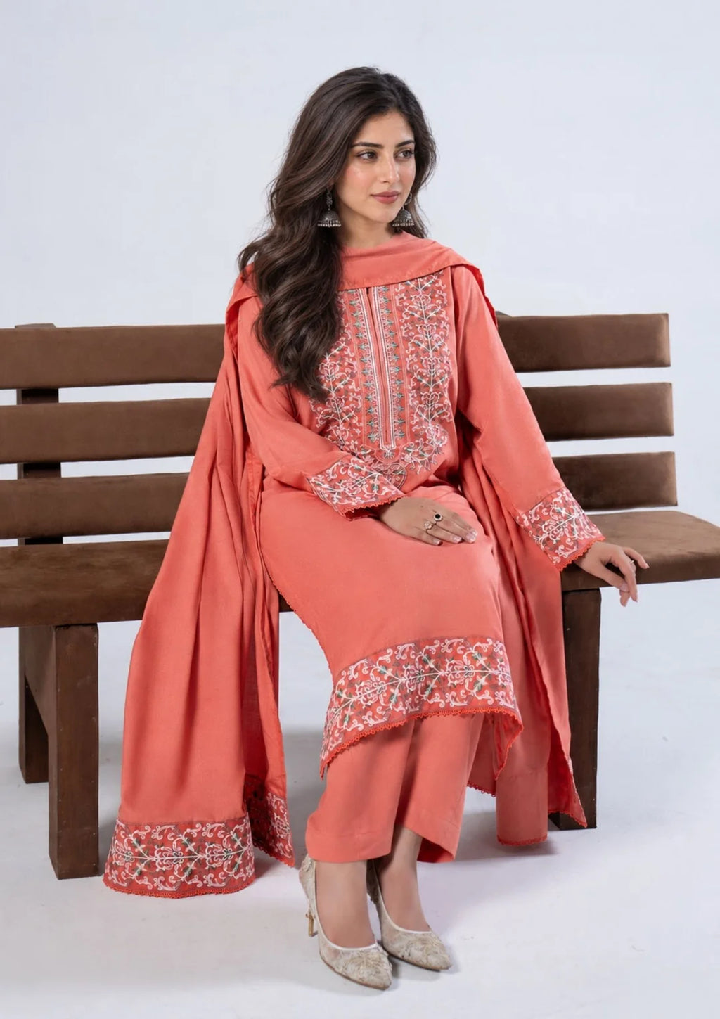 Coral winter suit styled with embroidered shawl