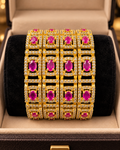 Gold and pink ruby 4-piece bangle set in jewellery box