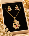 Gold and pink ornate pendant necklace with matching earrings and clear stones