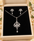 Silver-colour ornate pendant necklace with matching delicate drop earrings displayed in jewellery box