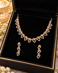 Gold and pink crystal heart-link necklace and matching earrings in a jewellery box