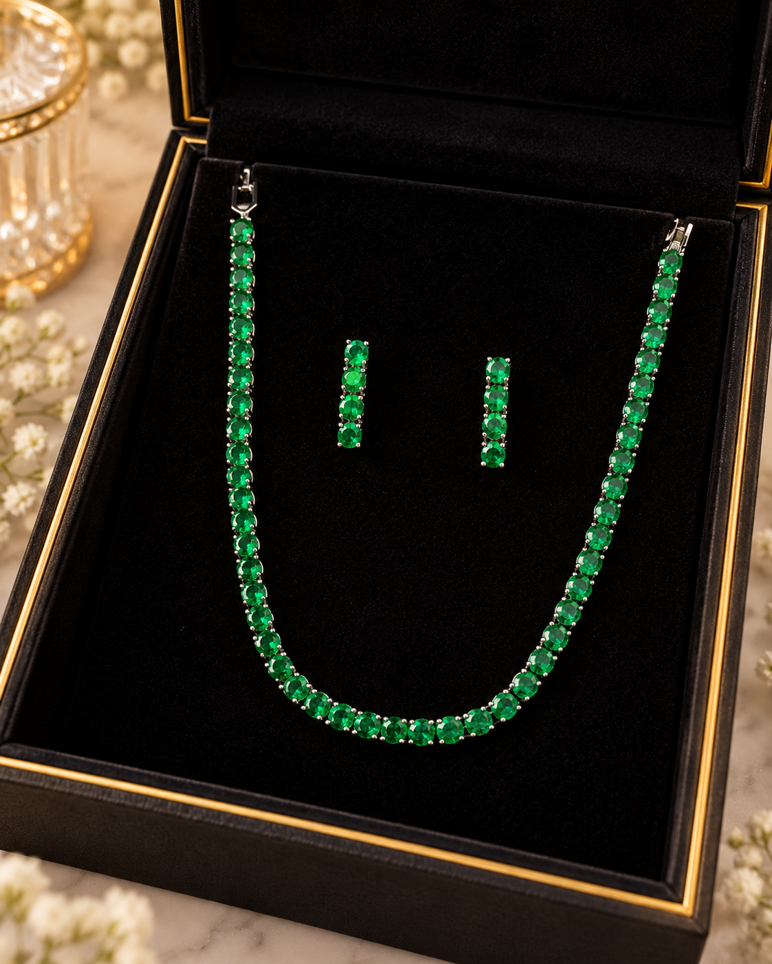 Silver and green crystal tennis necklace and matching earrings in a jewellery box